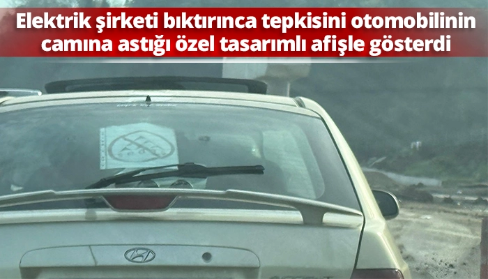 Elektrik şirketi bıktırınca tepkisini otomobilinin camına astığı &ouml;zel tasarımlı afişle g&ouml;sterdi