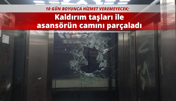 Kaldırım taşları ile asansörün camını parçaladı